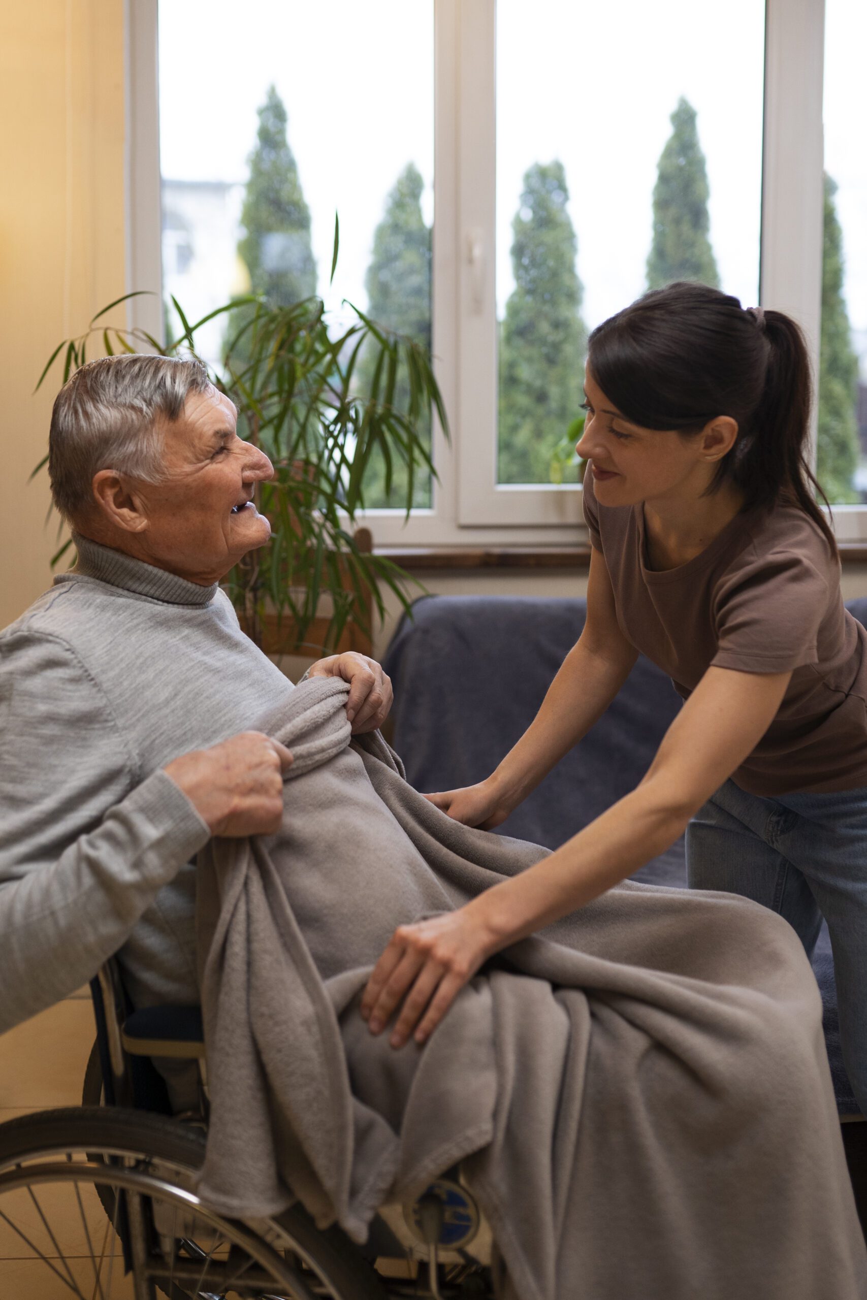 Elderly person being taken care of by female caretaker