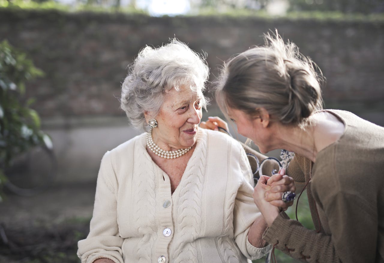 Elderly person being taken care of by female caretaker