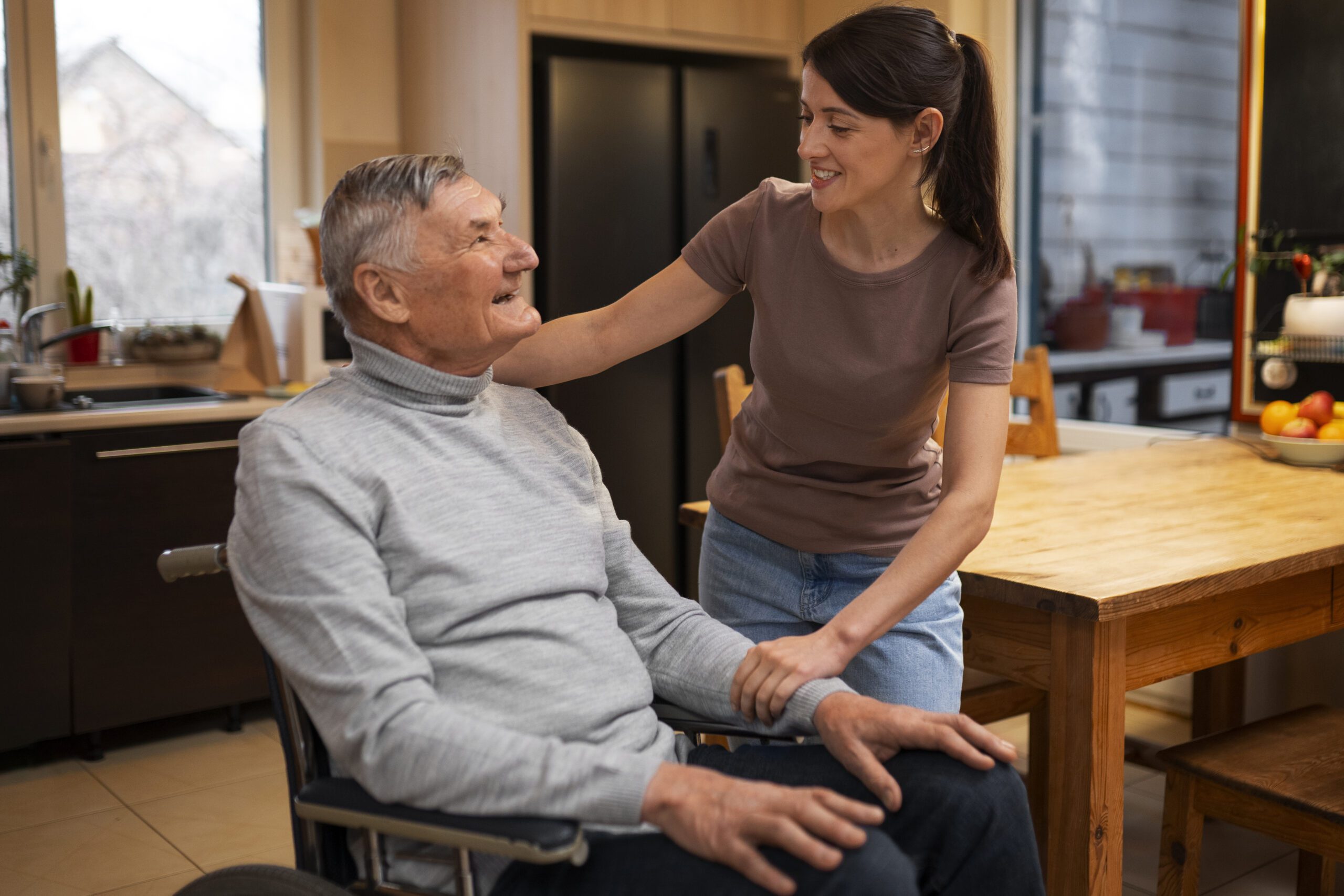 Elderly person being taken care of by female caretaker